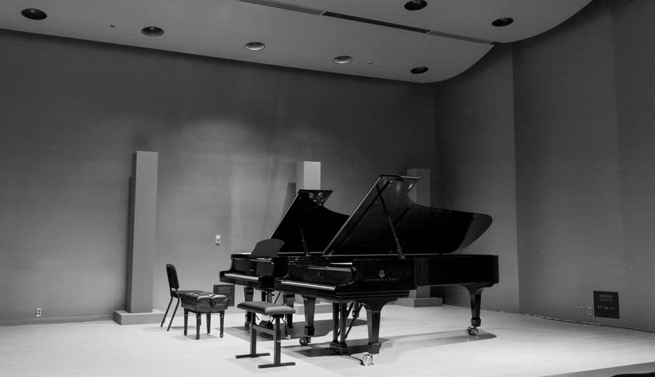A grand piano on a concert hall stage