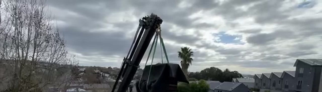 Specialist Movers crew lifting furniture to a balcony