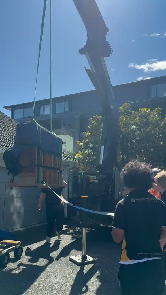 A piano lifted by crane on a Specialist Movers job