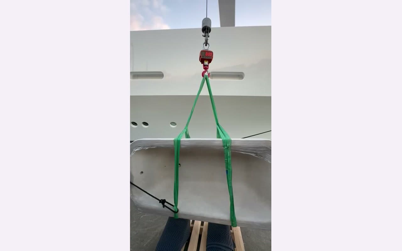 Two Specialist Movers guiding a heavy item through a doorway