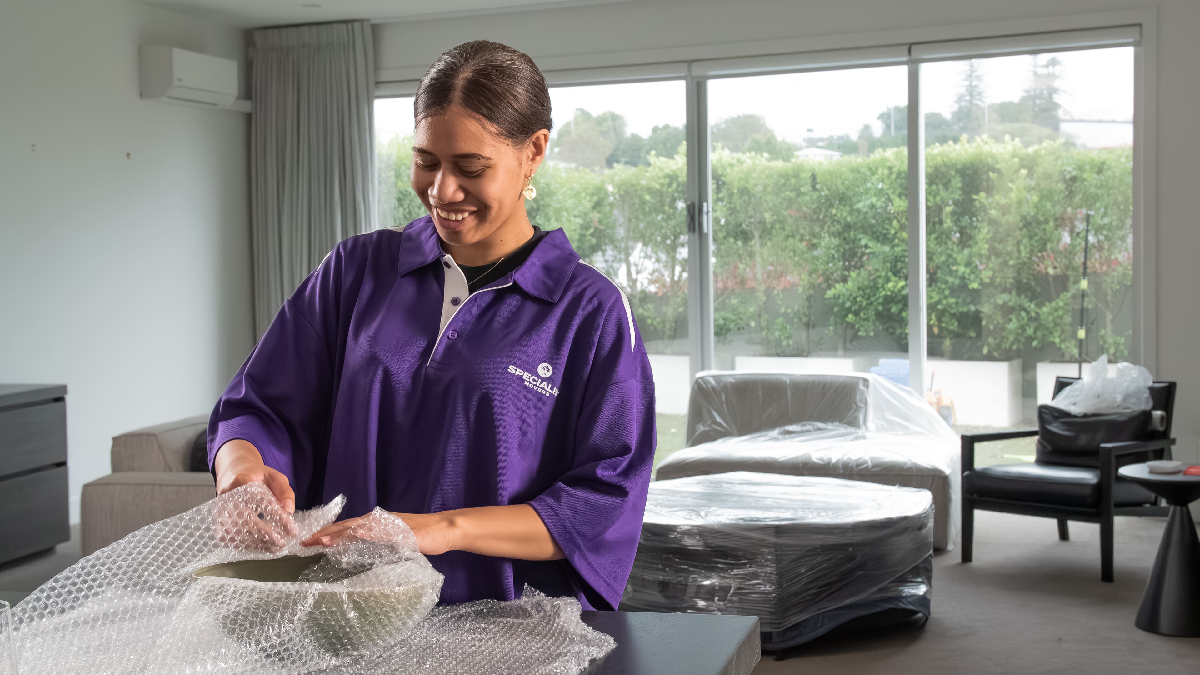 Specialist Movers team member wrapping items for transport